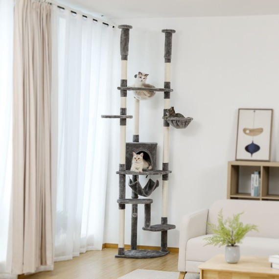 DualTower floor-to-ceiling cat tree in grey variant in a living room DualTower floor-to-ceiling cat tree in grey variant in a living room